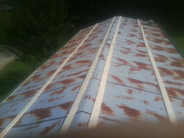 Rusted metal roof panels with new wood purlins before replacement — Storm Damage Roof Repair in French Camp by Roofing Brothers